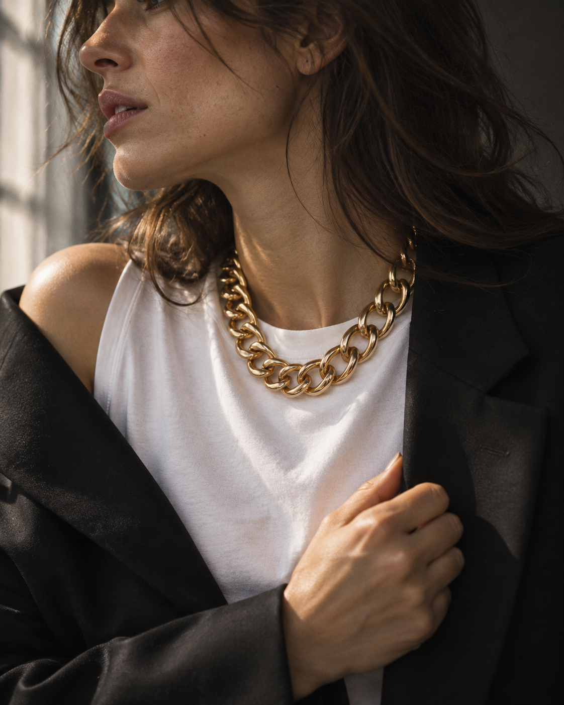 Editorial concept: chunky gold chain with white T-shirt and black blazer